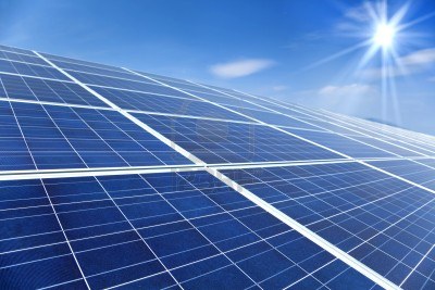 9545425-closeup-of-solar-panels-with-sunlight-and-blue-sky-background.jpg